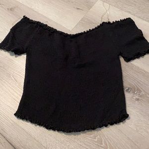 Tight fitting off the shoulder black top